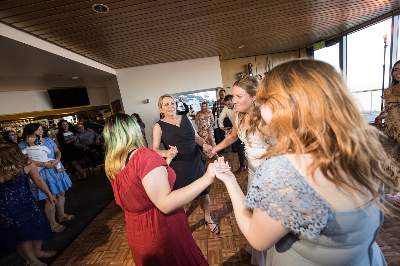 Ali dances holding hands with friends