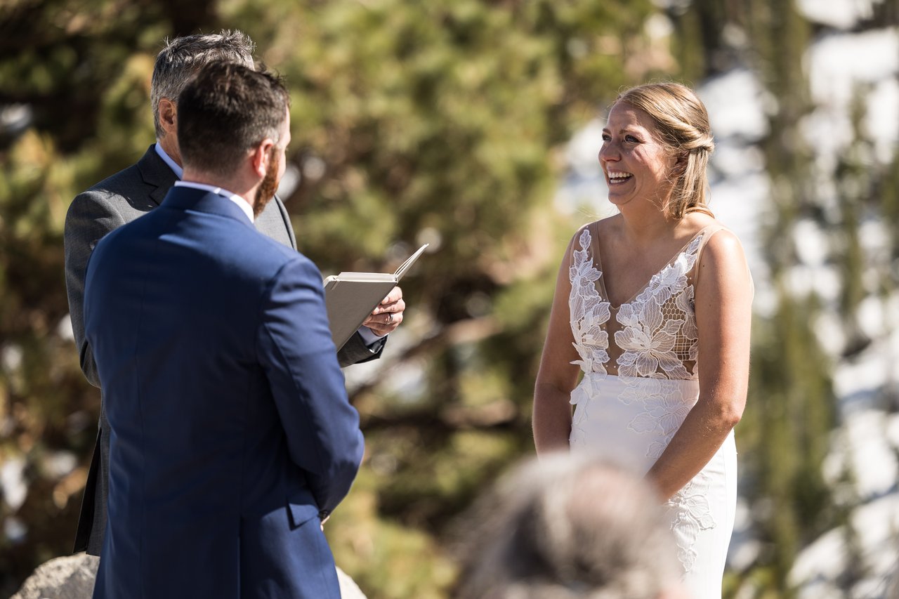 Ali laughs at the altar over Robert's shoulder