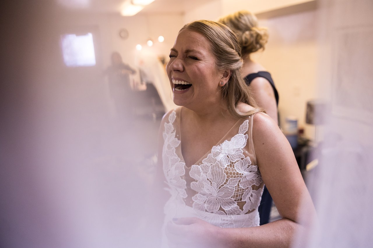 Ali laughs in her wedding dress before the ceremony