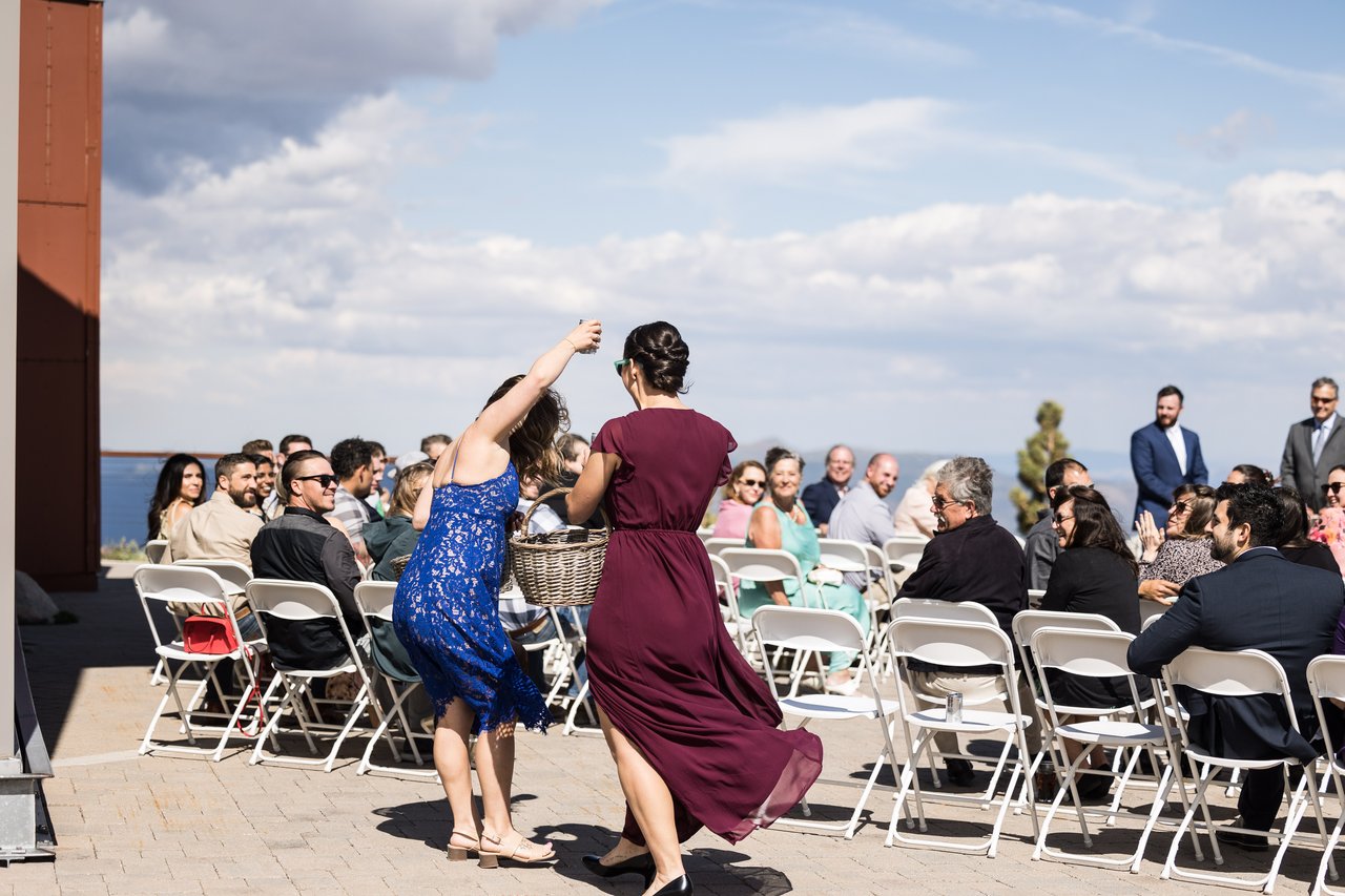 A beer girl cheers with guests in the aisle