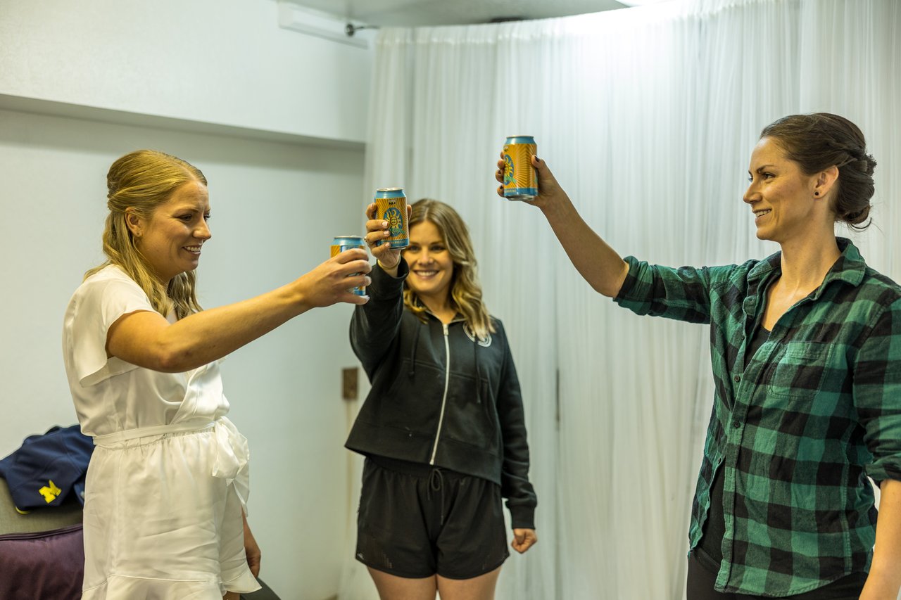 Ali raises a beer with friends as they arrive