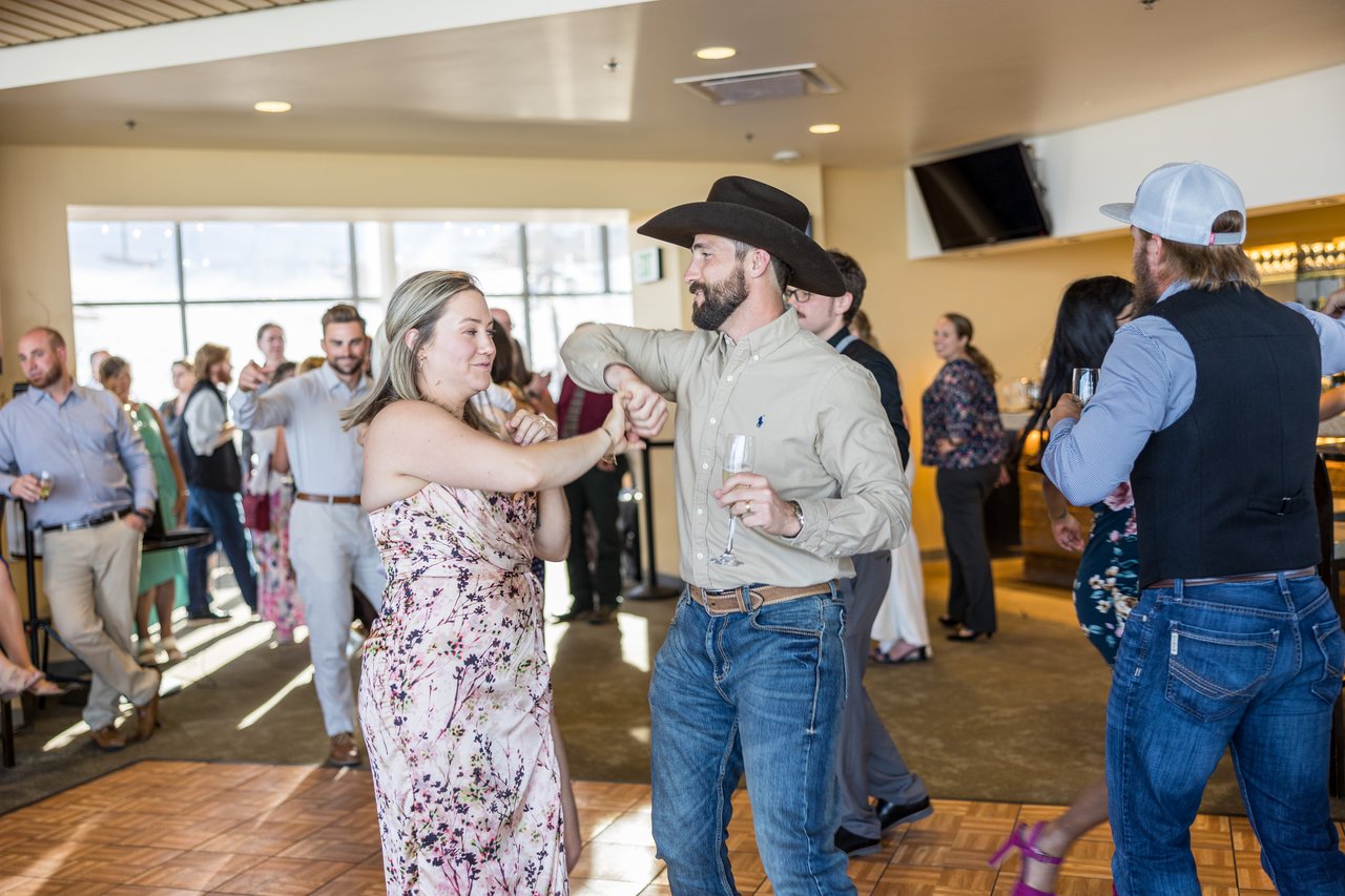Guests swing dance in a cowboy hat