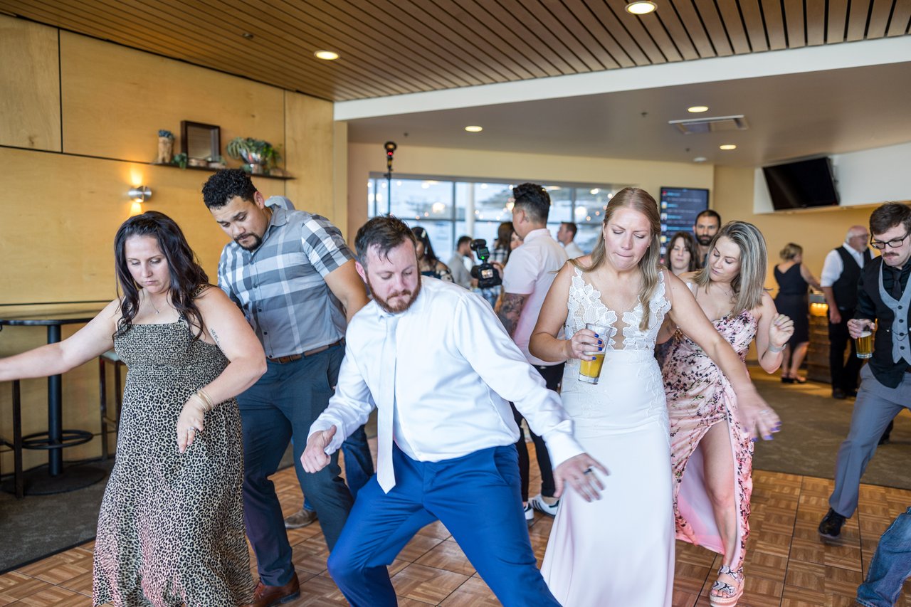 Ali and Robert dance in a line with friends
