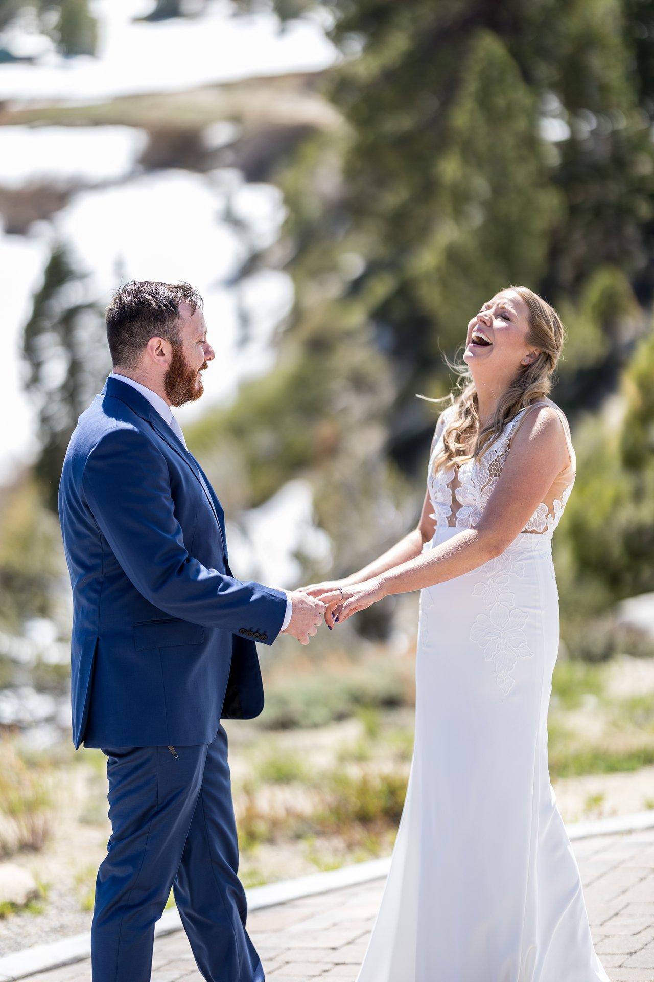 Ali and Robert laugh holding hands after the first look