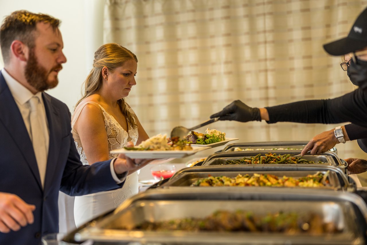 Ali and Robert get their first plates at the buffet