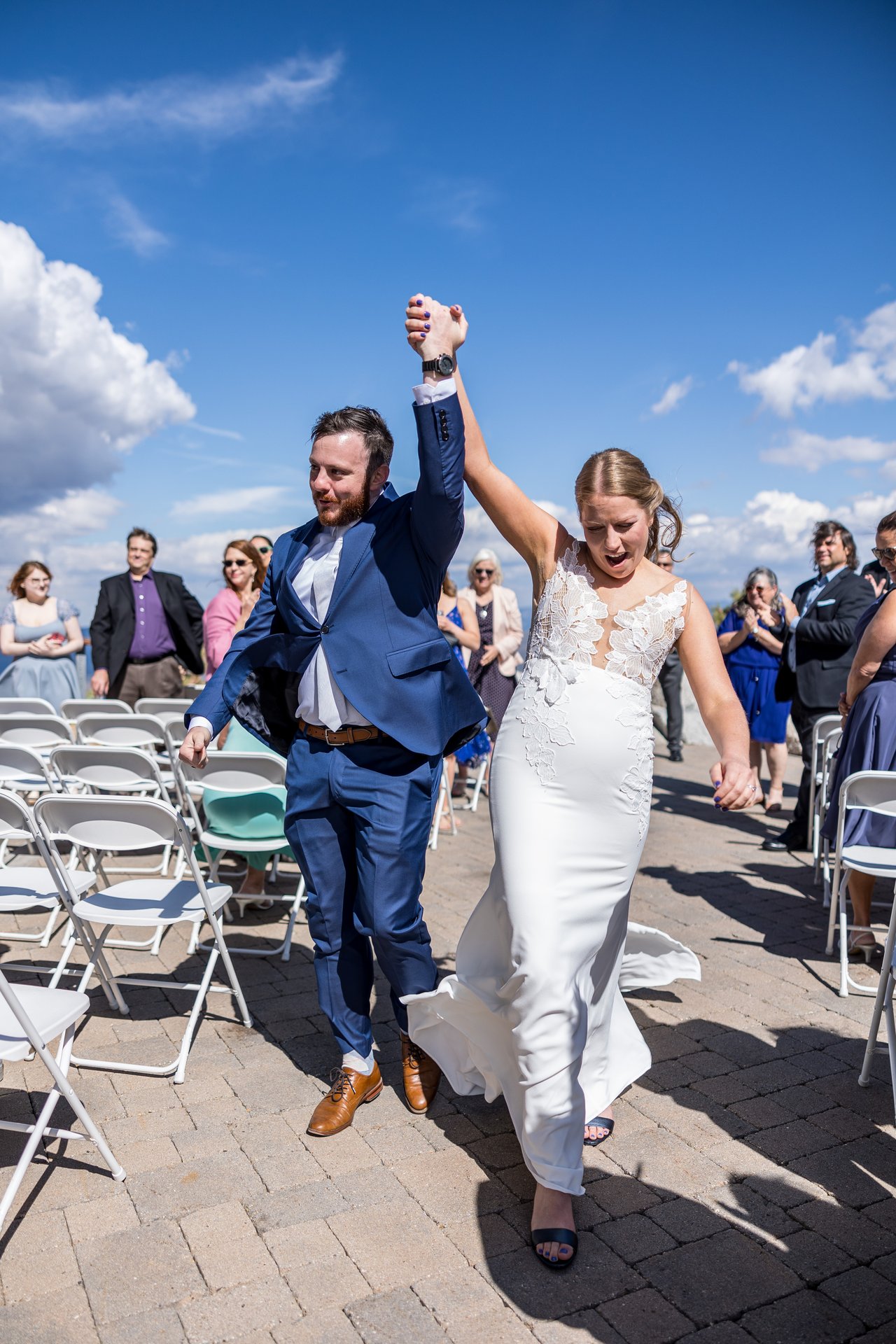Robert pumps his fist as they walk back up the aisle