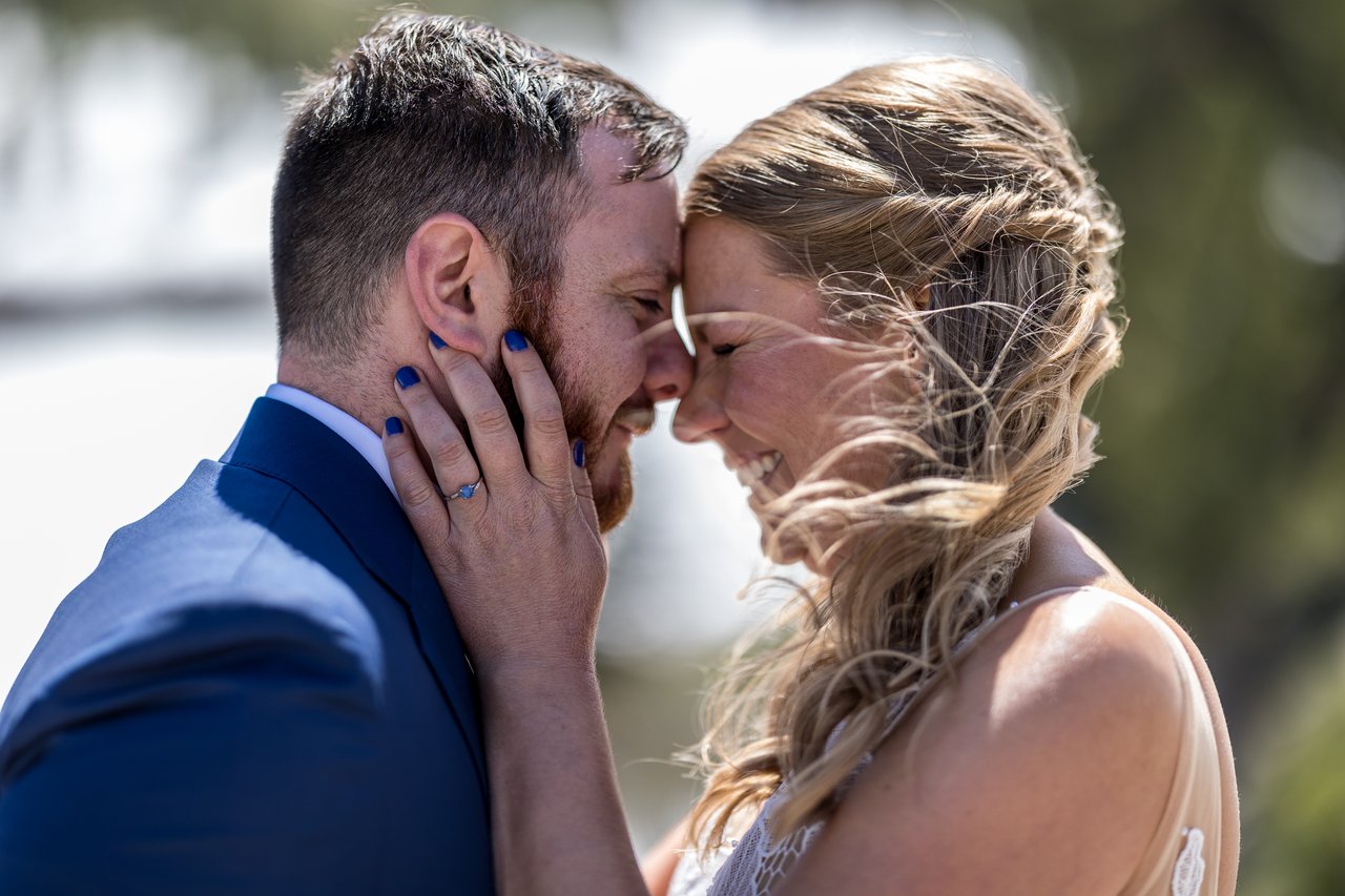 Ali and Robert touch foreheads as the wind catches her hair