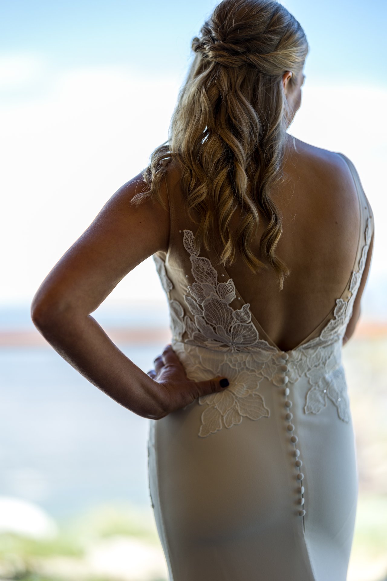 The lace back of Ali's dress by the window