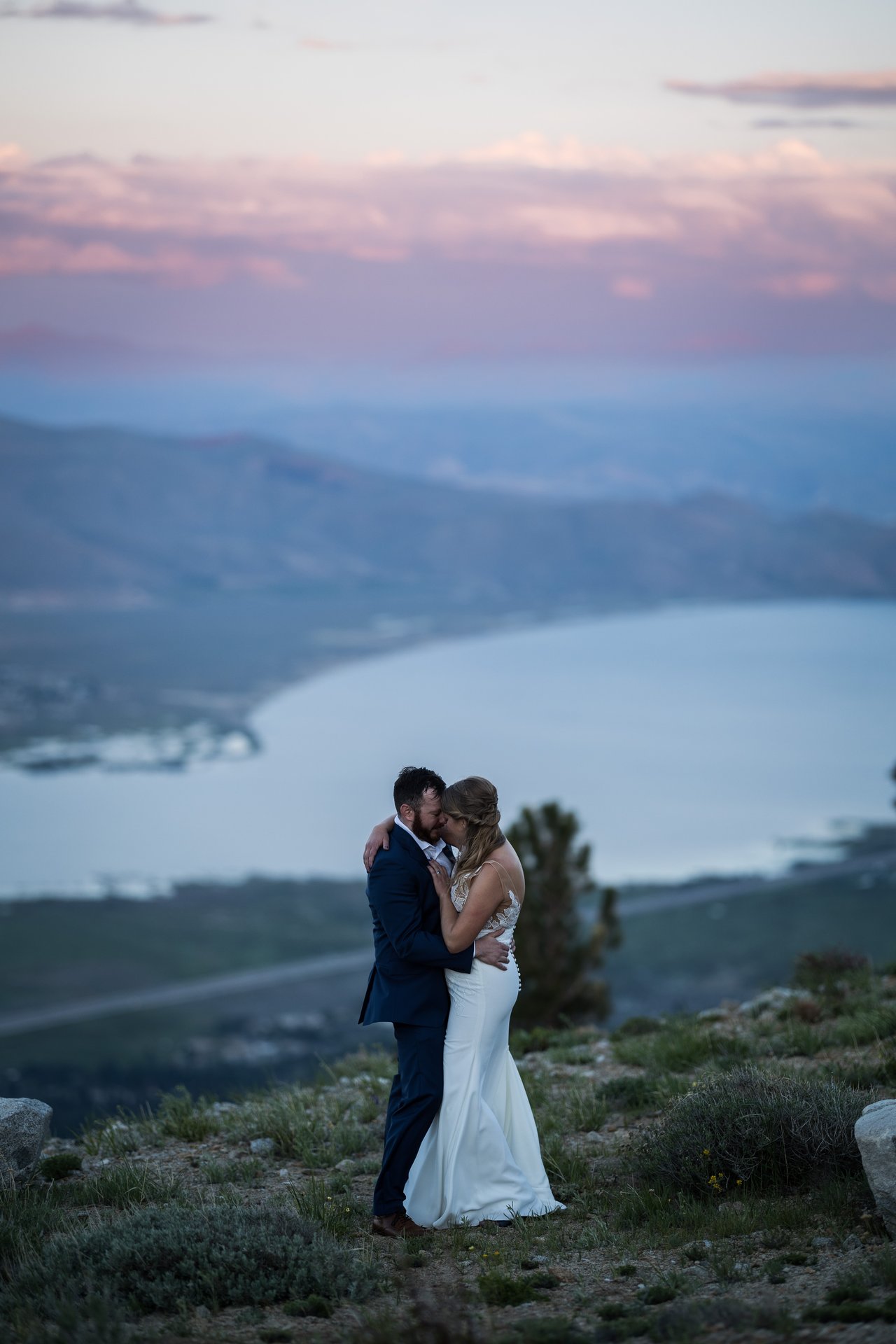 Ali and Robert under a pink sky over the lake