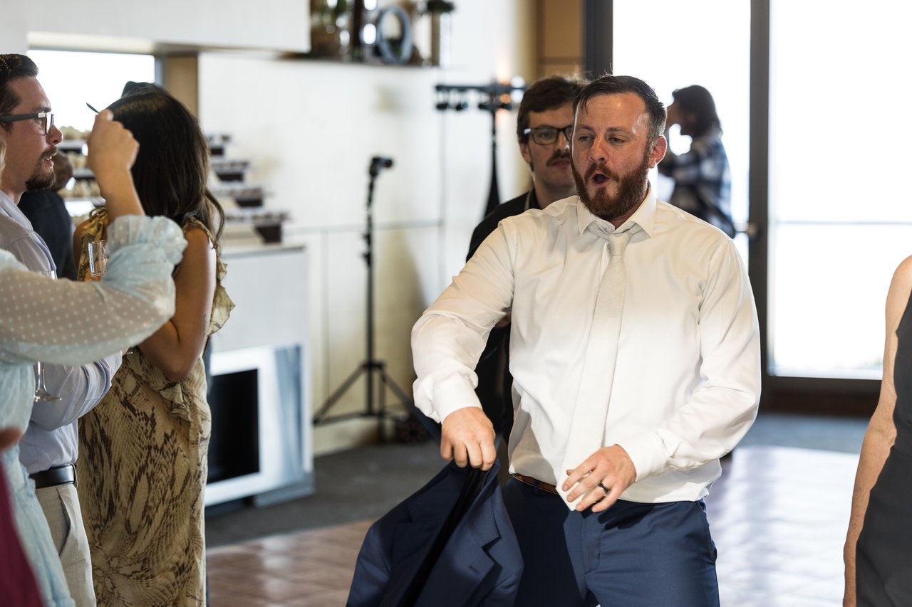 Robert takes off his jacket ready to dance