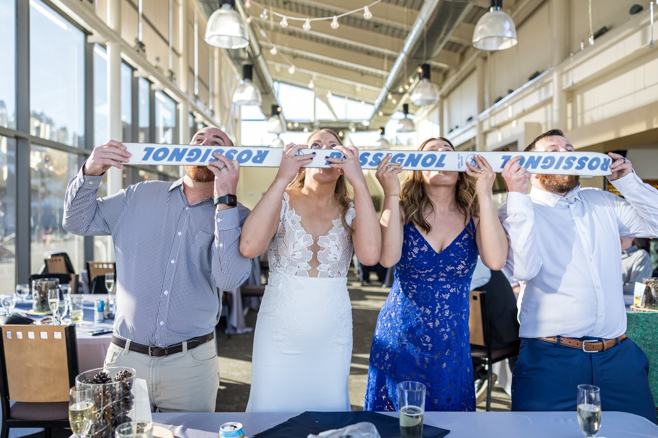 Ali and friends take a shot from a shot ski