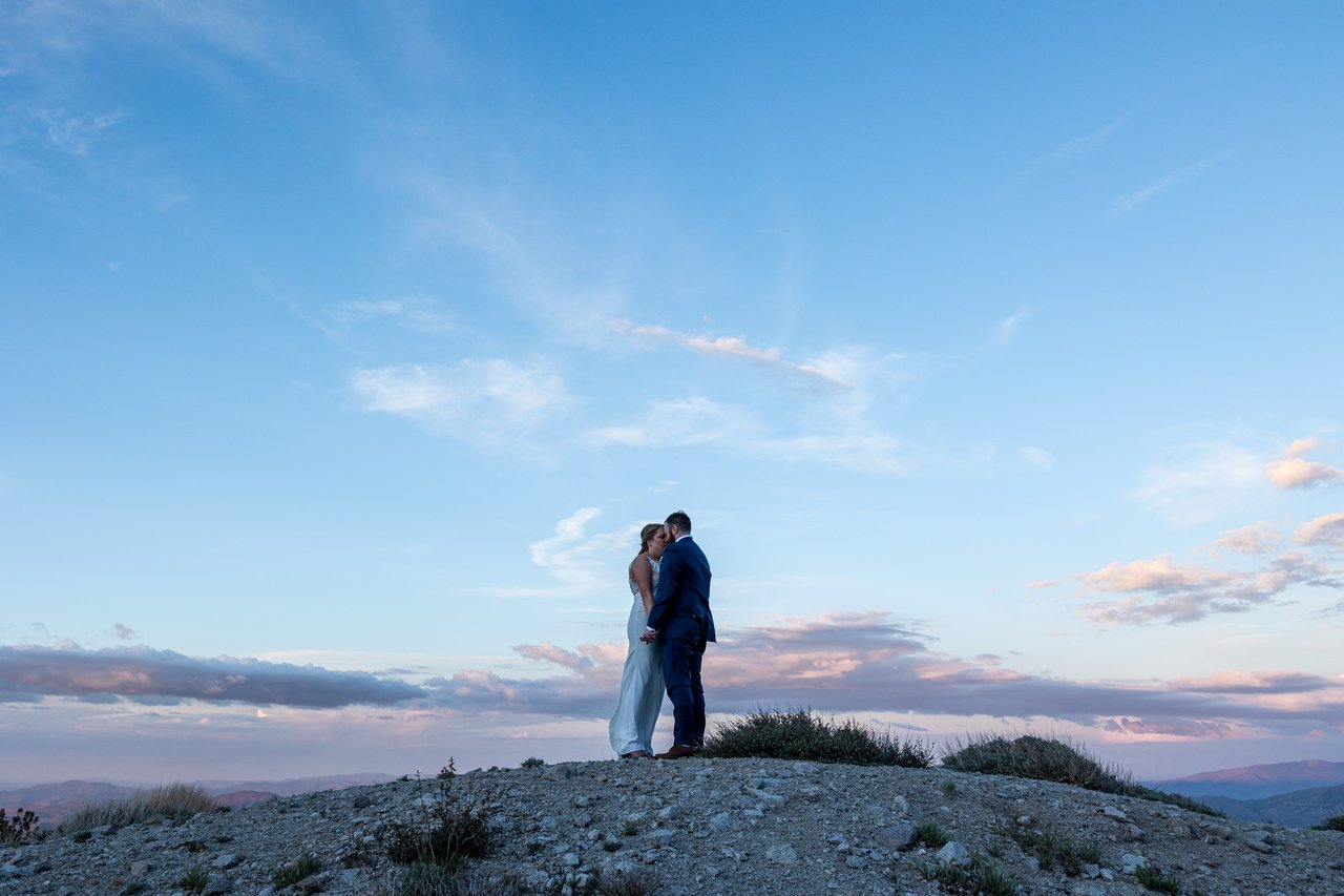 Ali and Robert on the summit under a big dusk sky