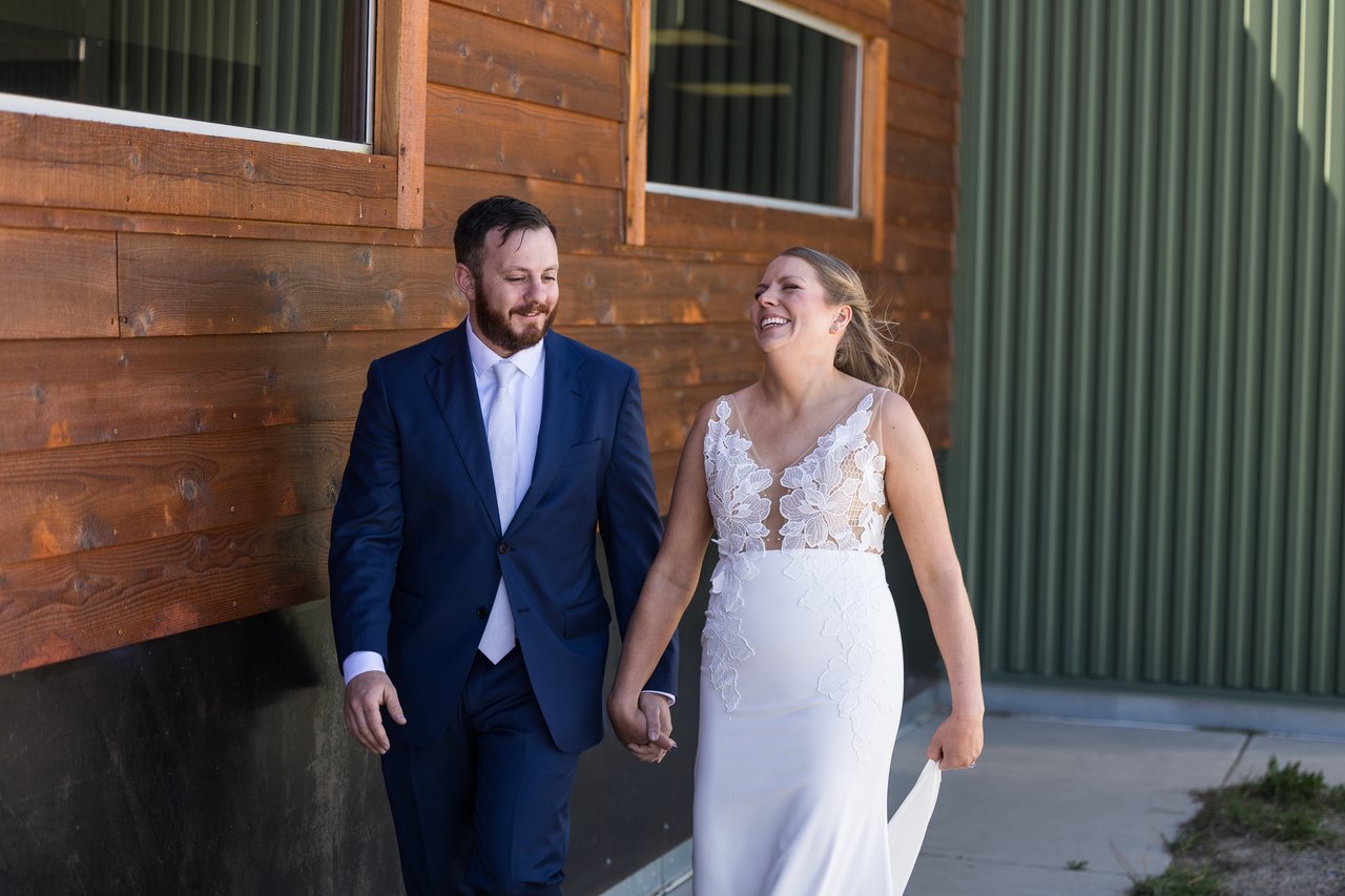 Ali and Robert laugh as they walk hand in hand