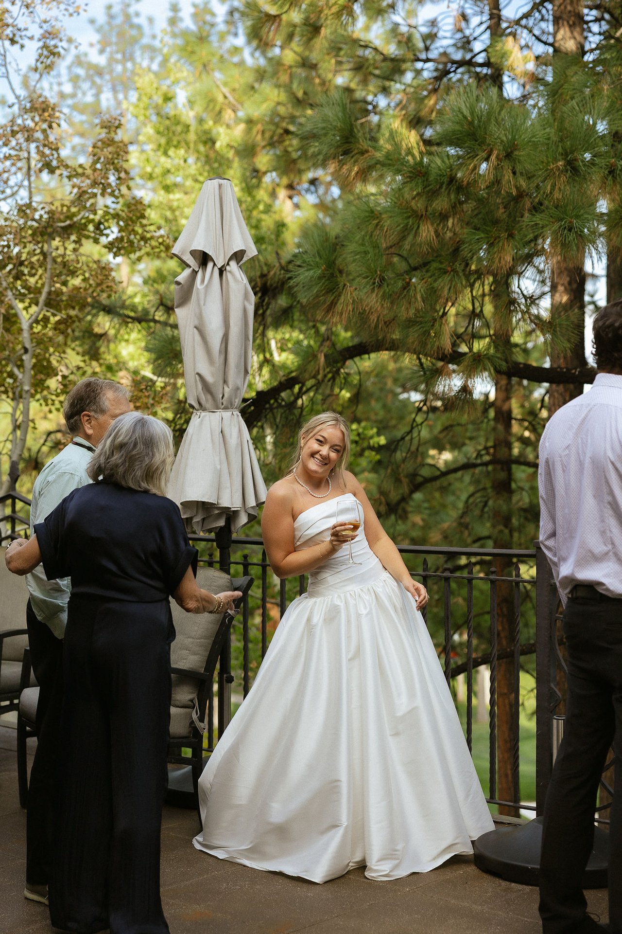 Ally laughs with her guests on the deck