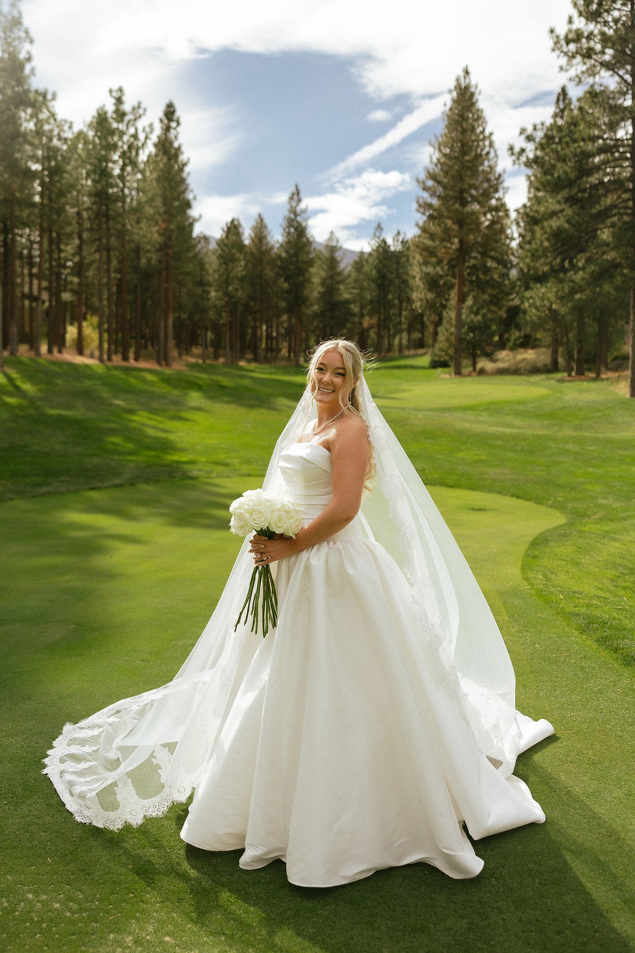 Ally holds her bouquet of white roses
