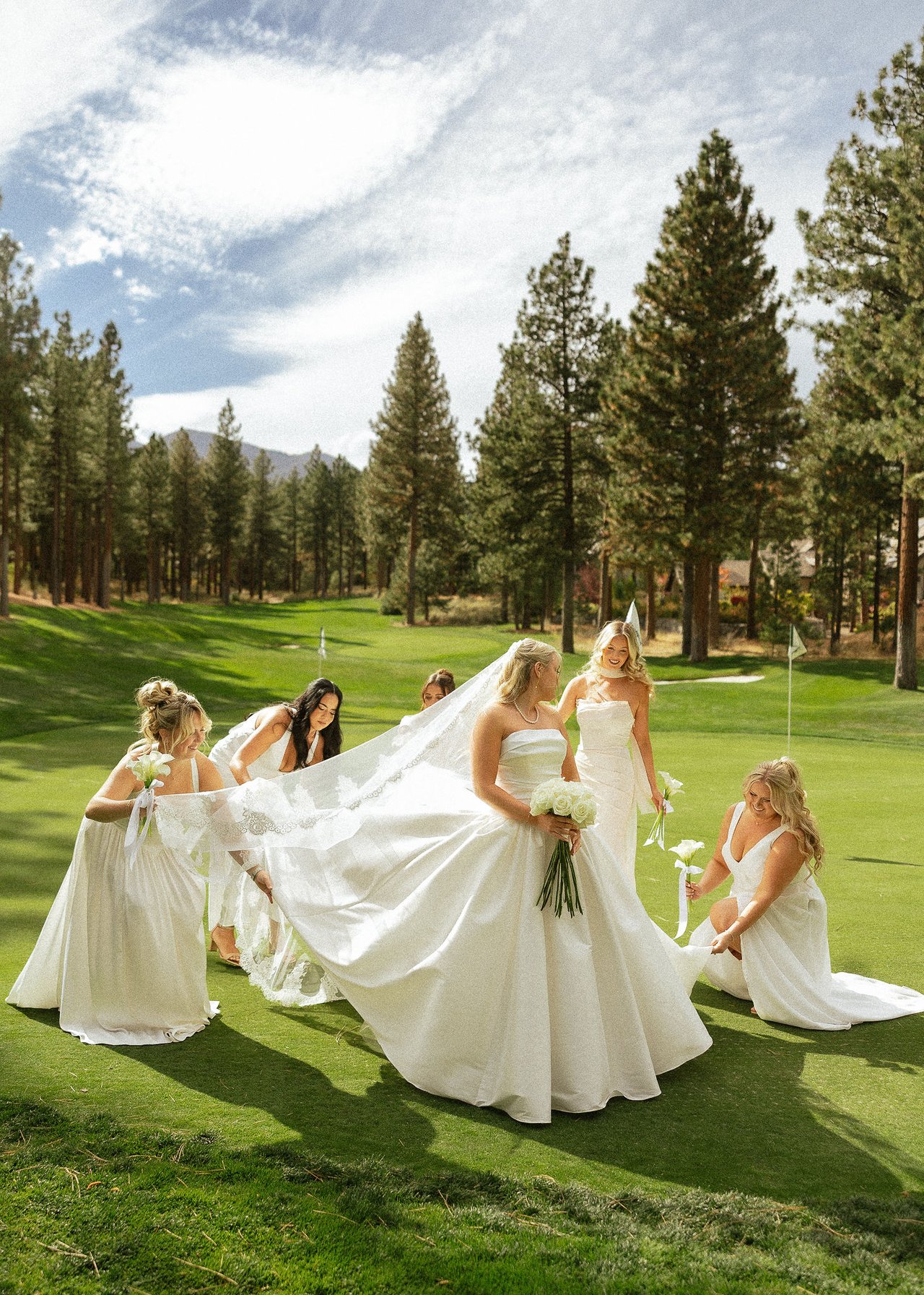 Ally's bridesmaids fluff out her veil