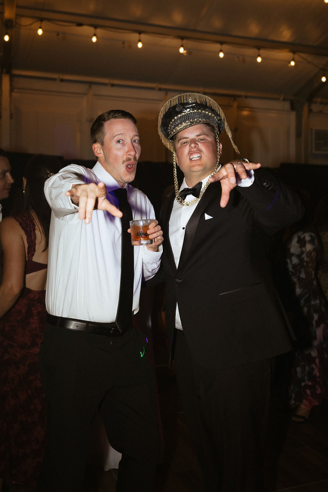 Drew dances in a captain's hat on the dance floor