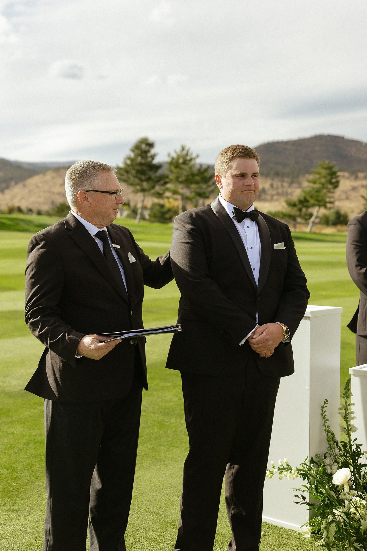 Drew waits at the front with the officiant before the ceremony