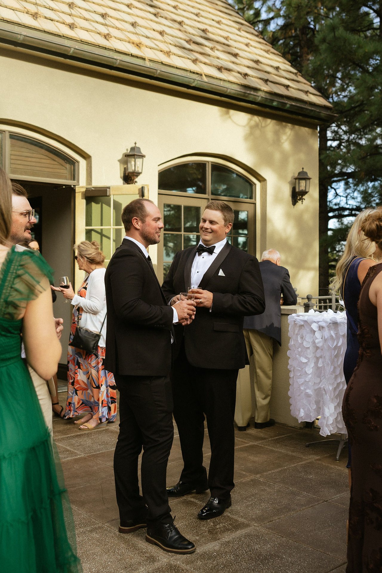 Drew talks with a guest on the patio