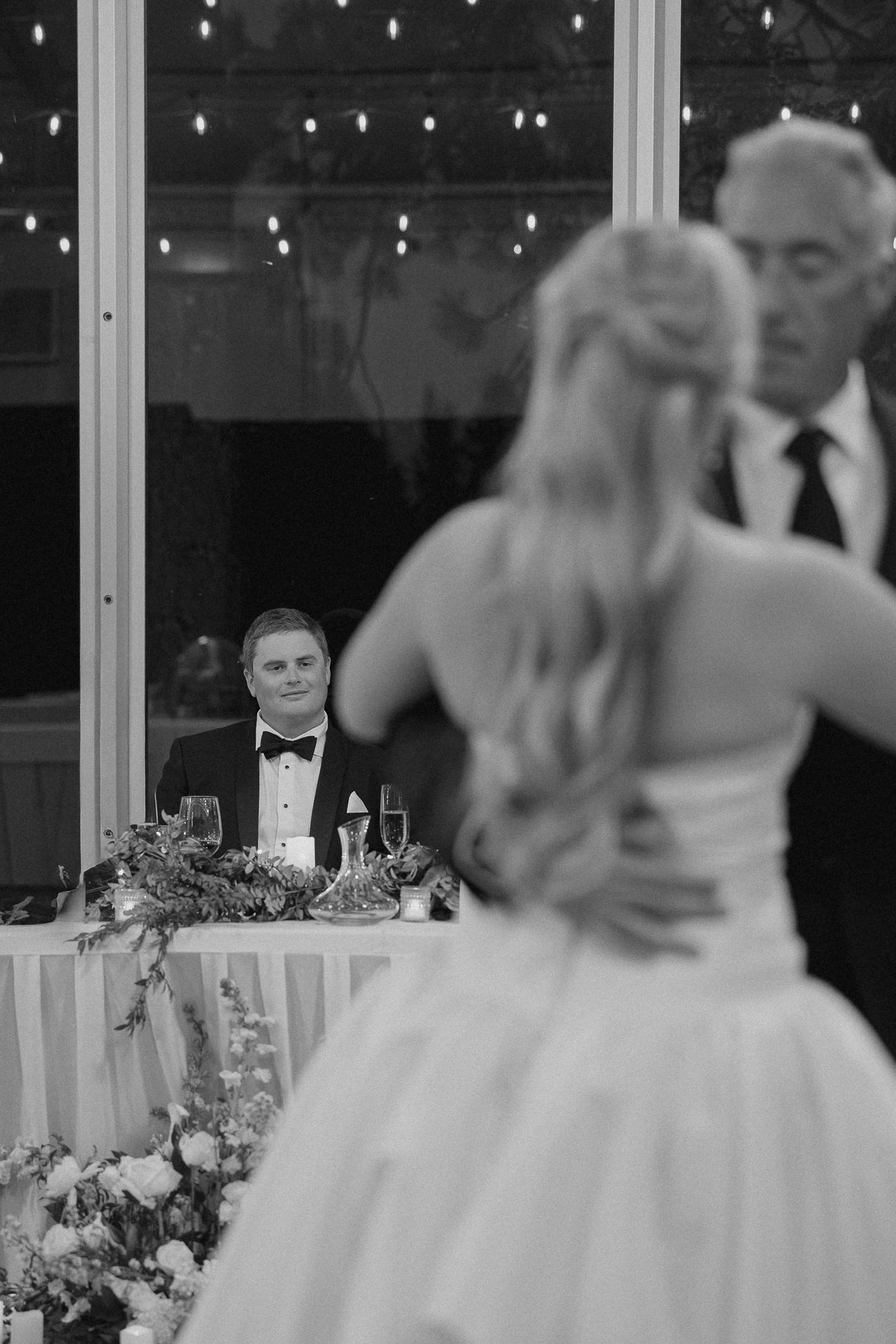 Ally dances with her dad as Drew watches, in black and white