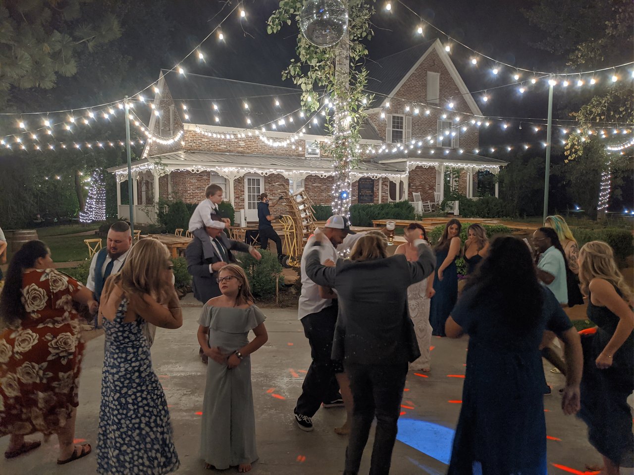 Guests keep dancing late into the night under the string lights