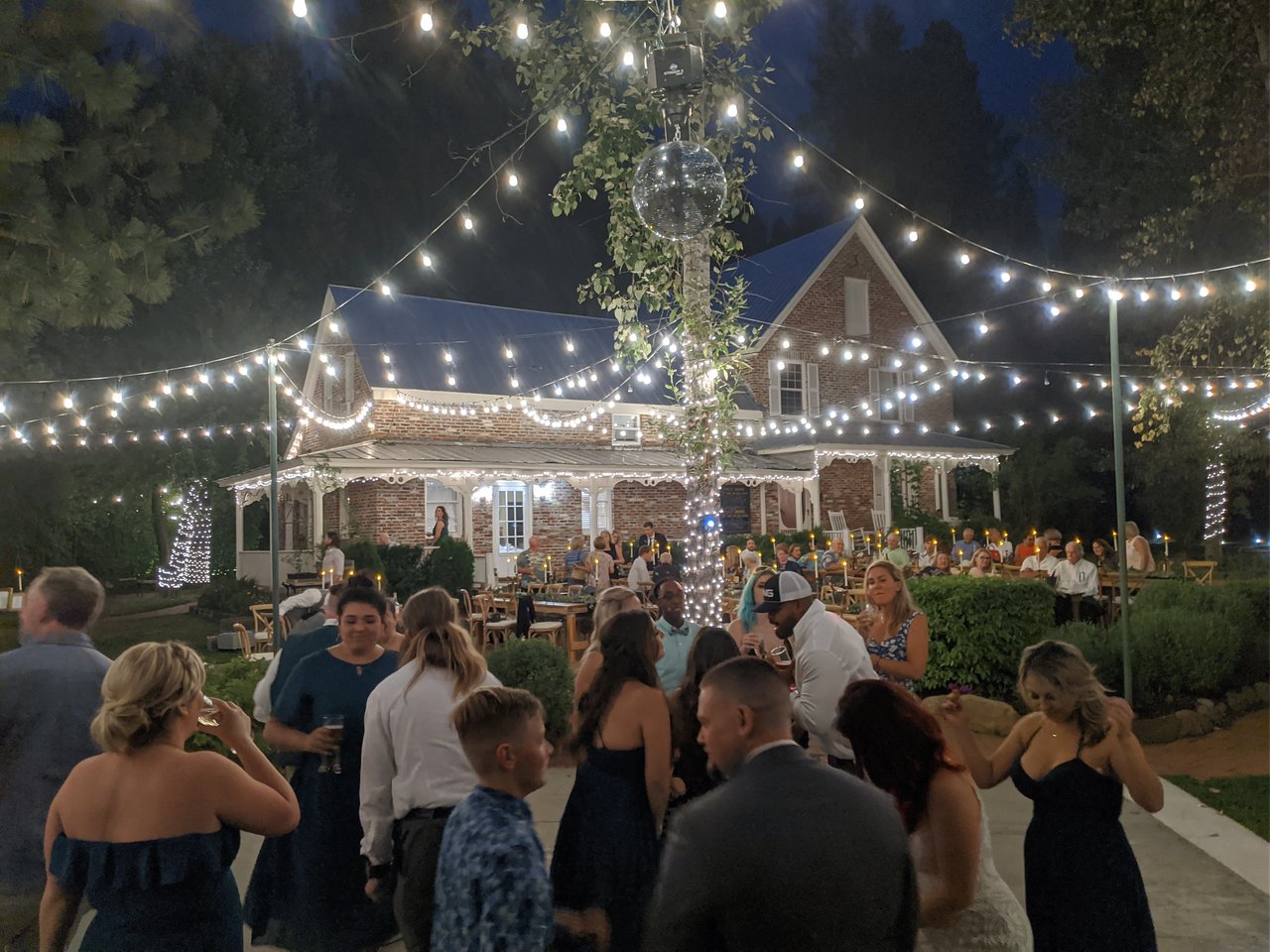 A full dance floor under the string lights after dark at Twenty Mile House