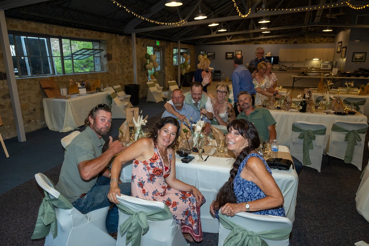 Friends smile for the camera at their table