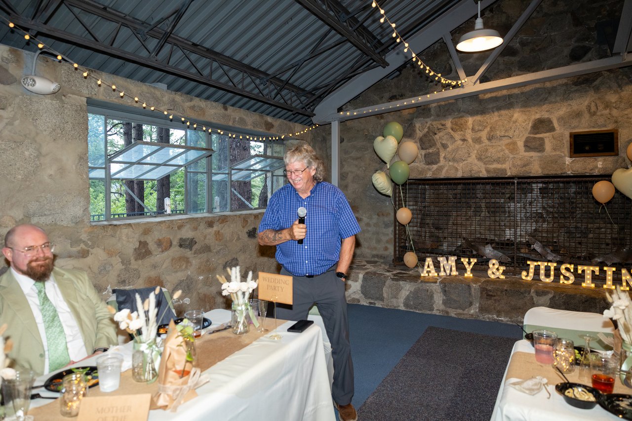 A family friend gives a toast by the fireplace