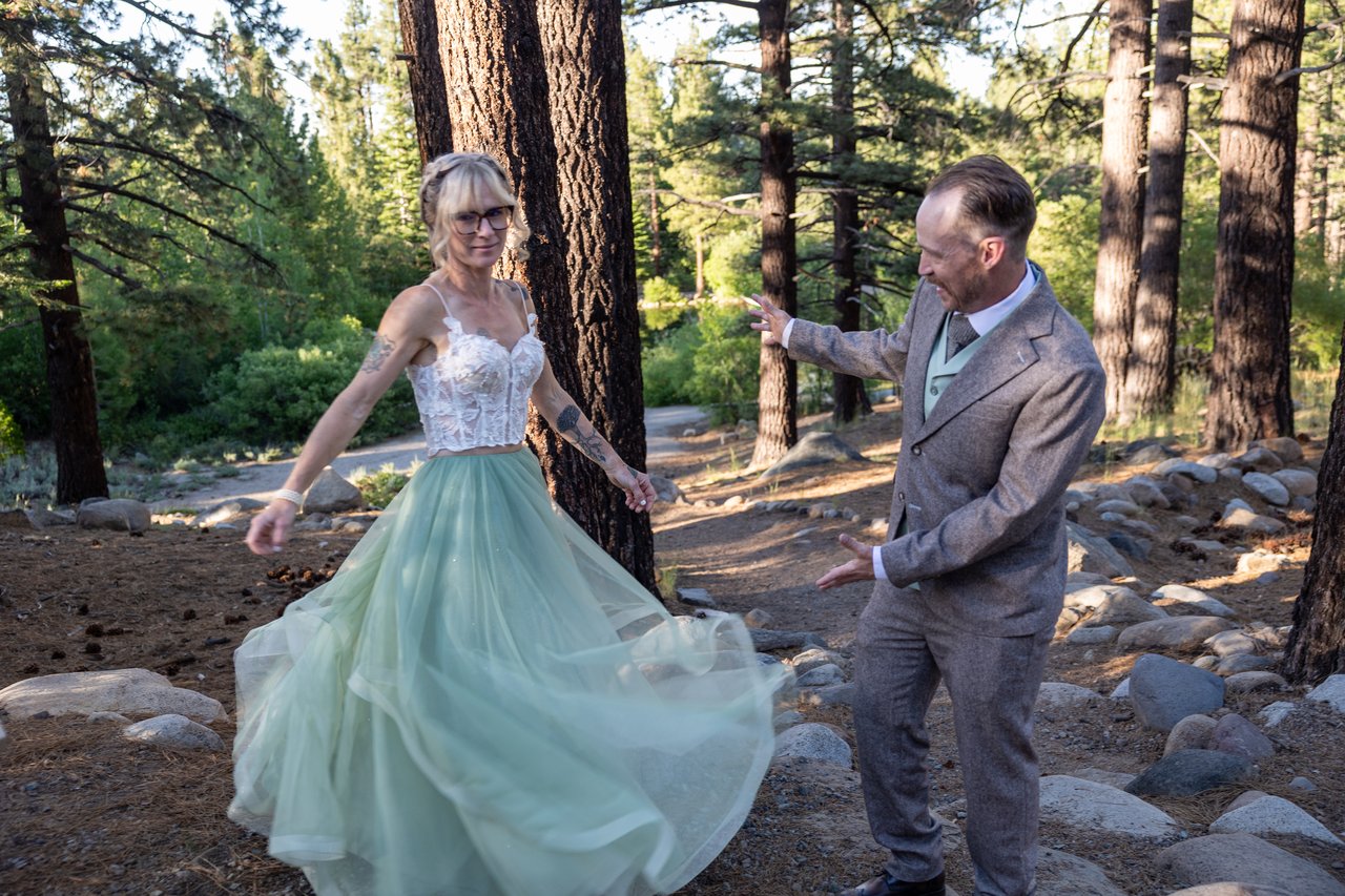 Amy spins her sage skirt in the pines while Justin laughs