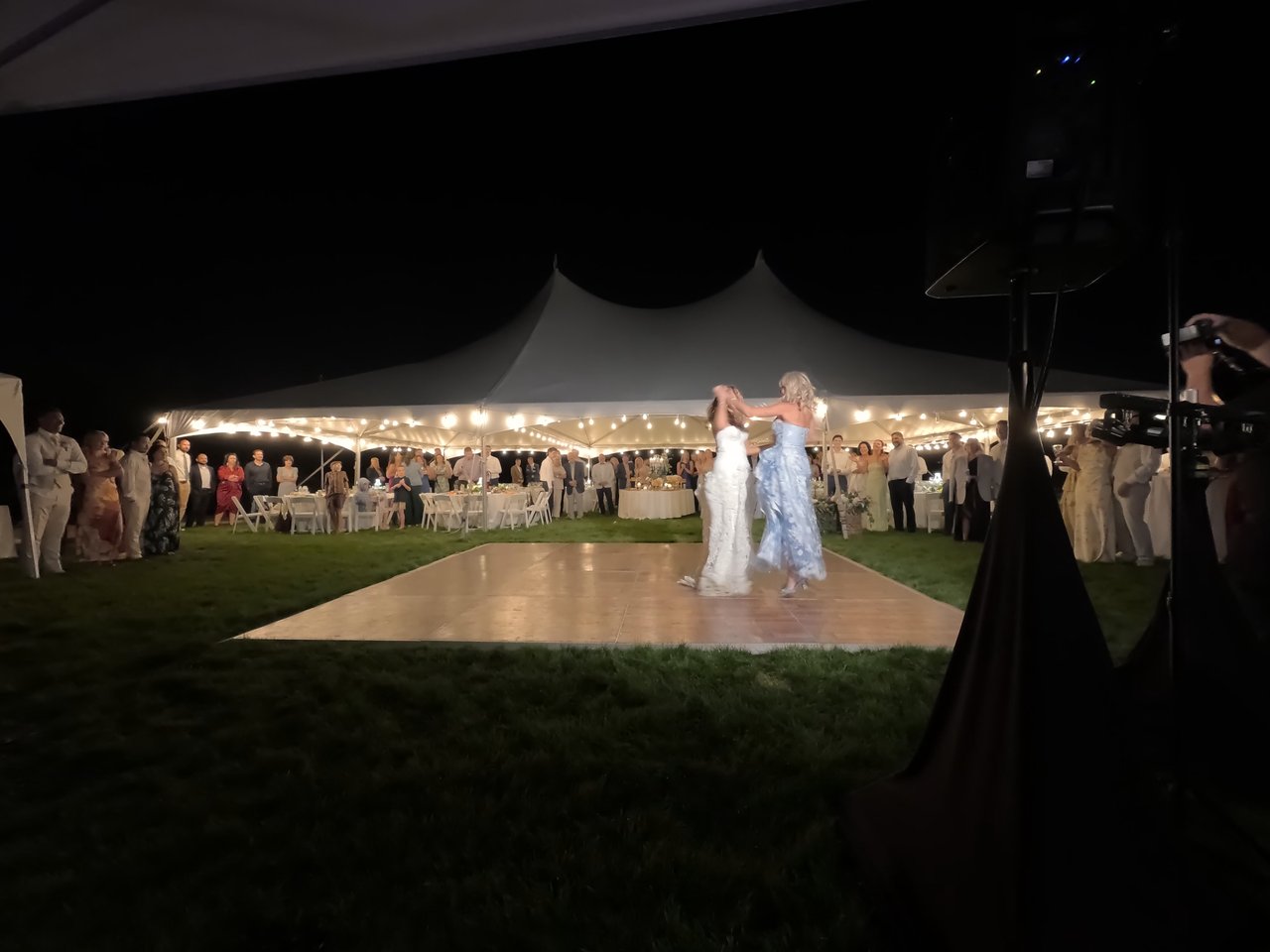 Anabella shares a traditional dance on the lawn dance floor under the tent lights