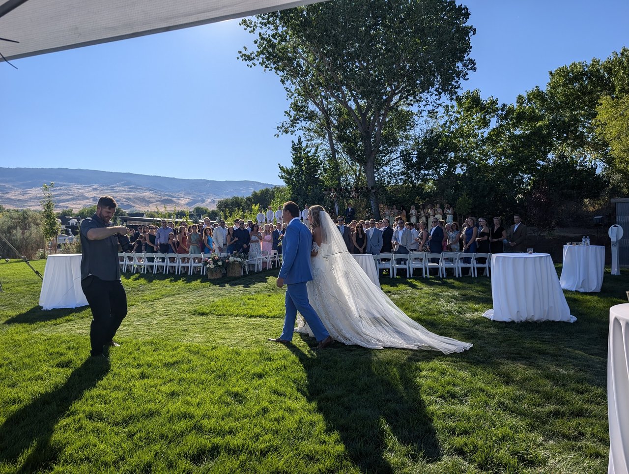 Anabella and Wyatt walk the aisle together on the ranch lawn