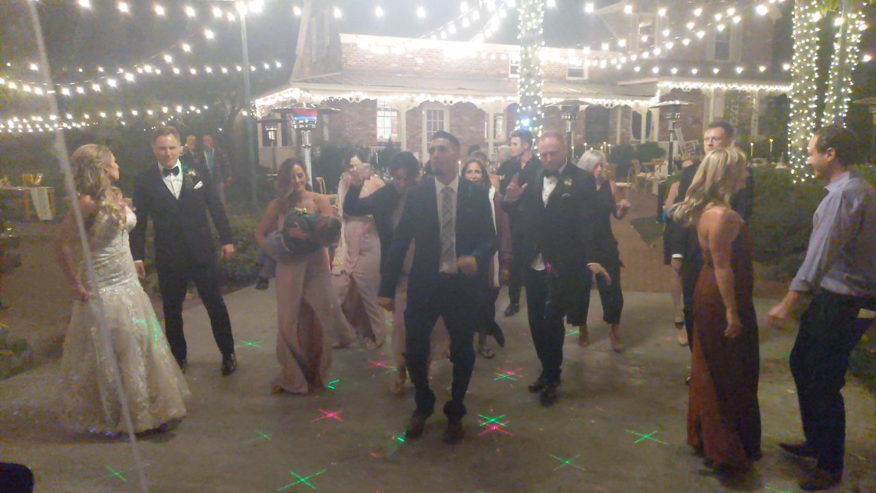 Angela and her guests dance under the string lights at night