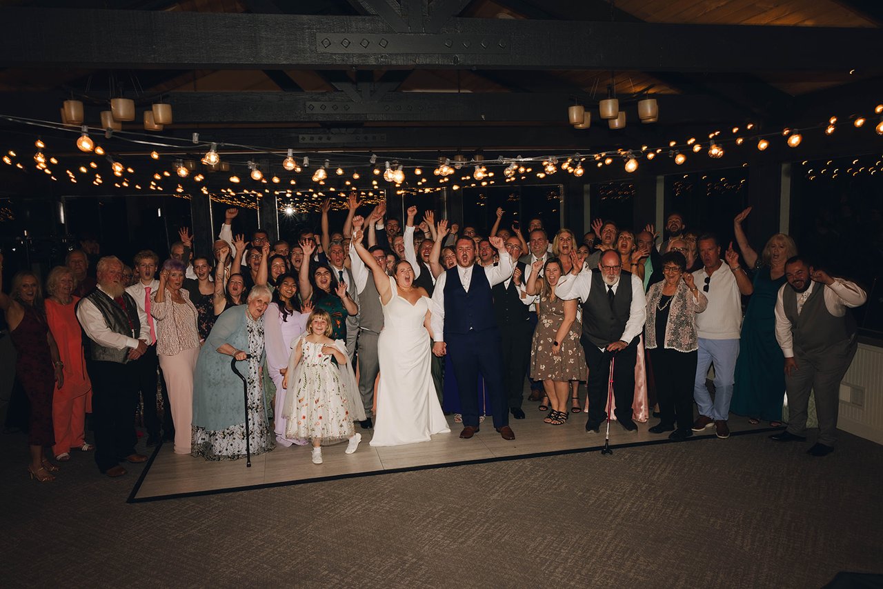 Every guest gathered on the dance floor with hands up around Autumn and Peter