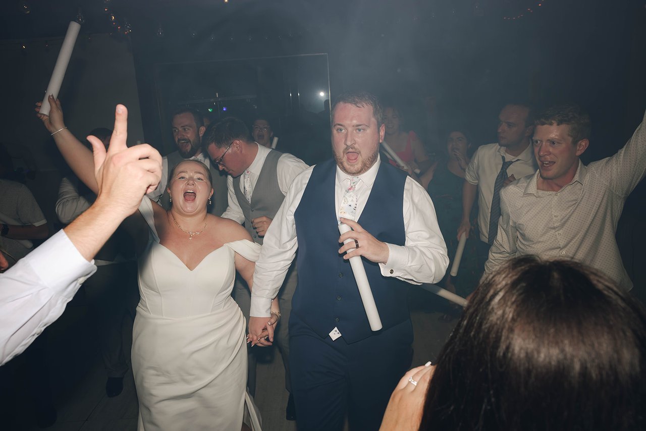 Autumn and Peter sing along on the dance floor with guests all around them