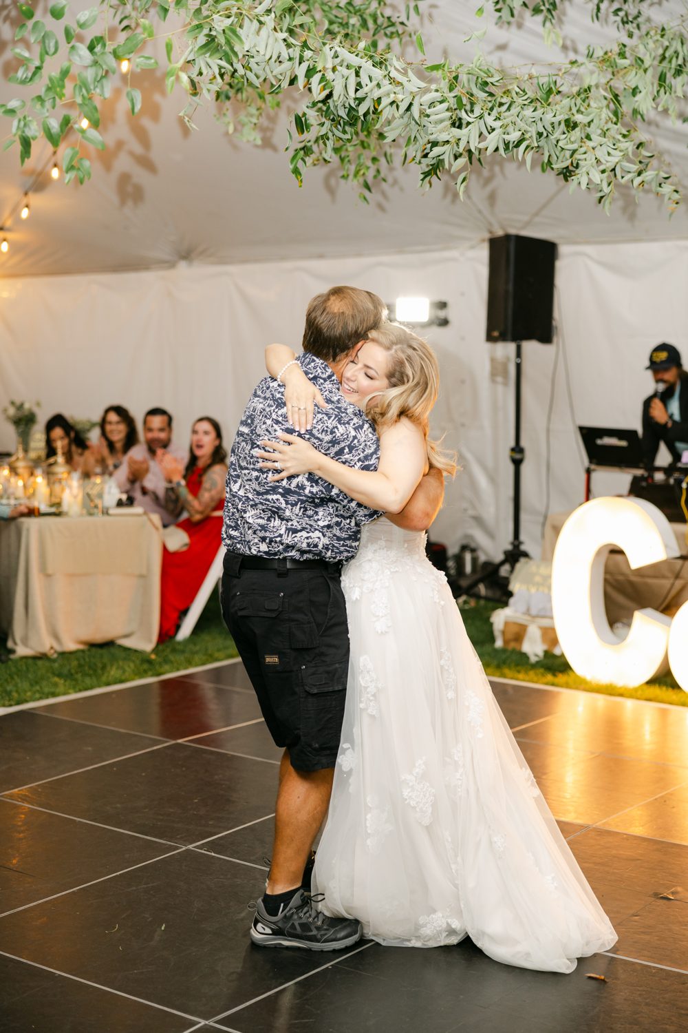 Britt and Chris embrace on the dance floor at their tented reception