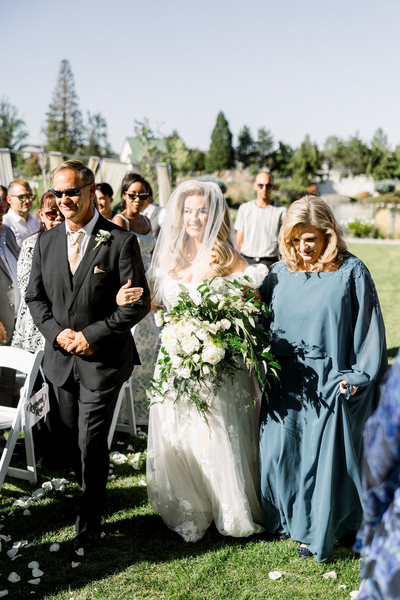 Britt walks down the aisle between two family members