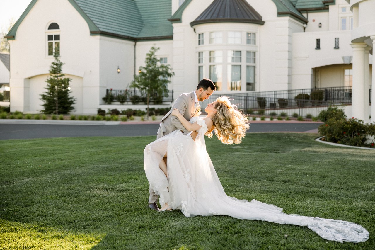 Chris dips Britt for a kiss on the lawn in front of the clubhouse