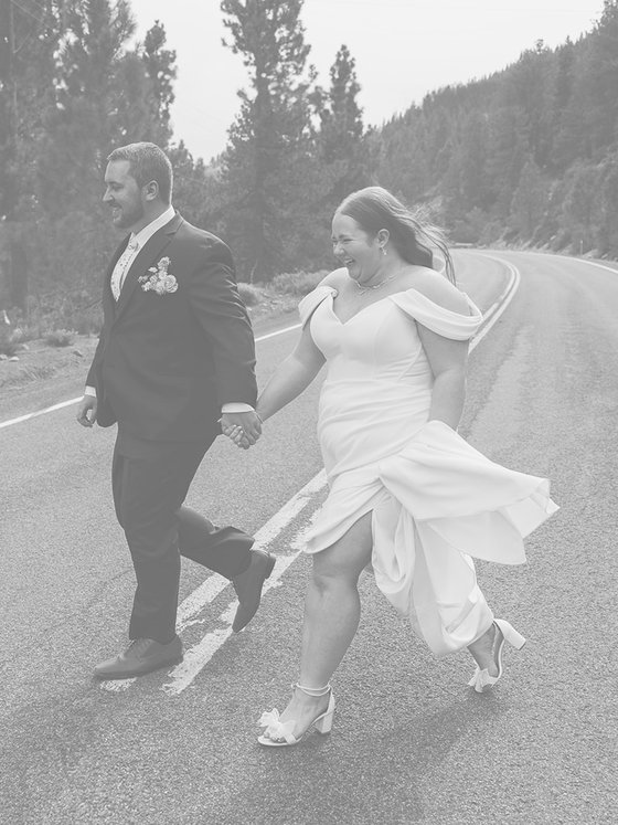 Autumn and Peter walk hand in hand across the Mt. Rose Highway, in black and white