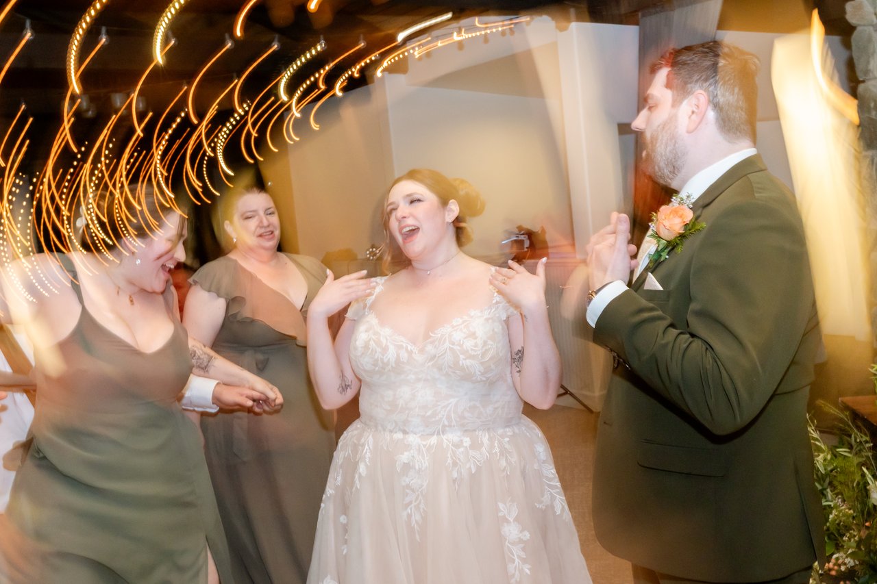 Danielle laughs on the dance floor with her bridesmaids and Brandon