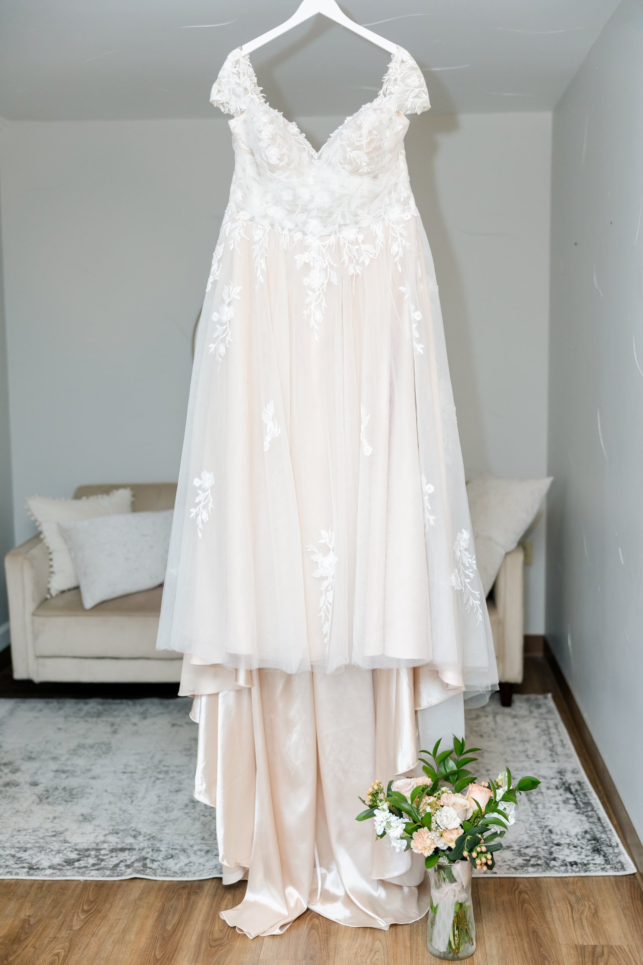 Danielle's lace wedding gown hanging in the suite