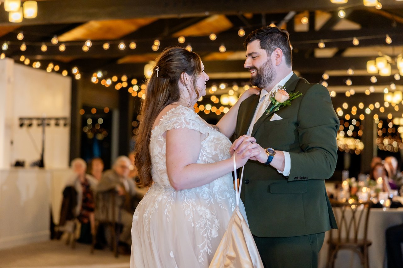 Danielle and Brandon smile at each other during their first dance