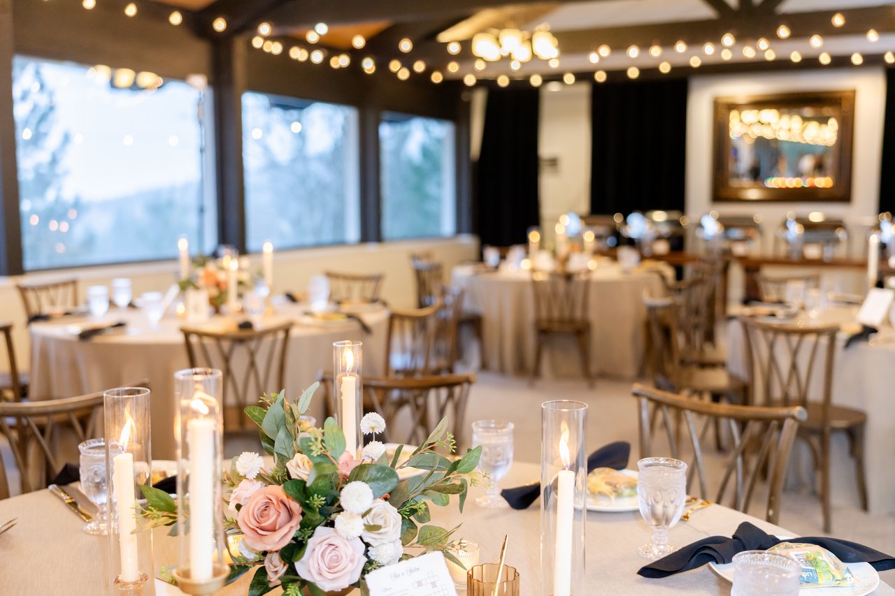 Reception tables with candles and roses under the string lights