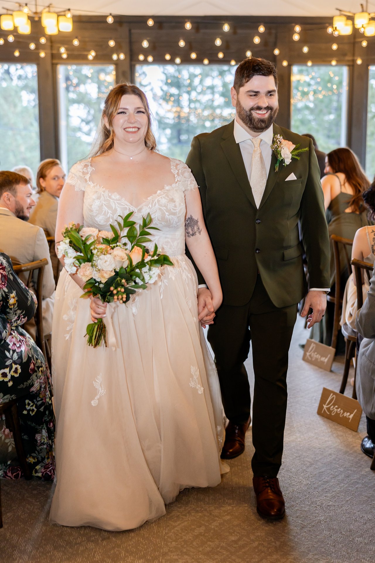 Danielle and Brandon walk back up the aisle smiling
