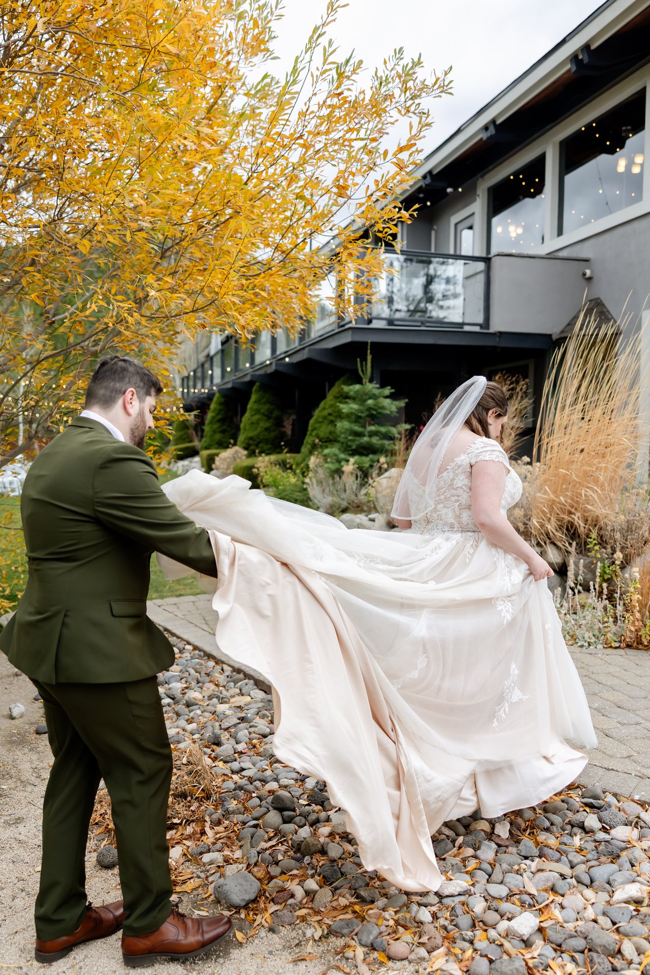 Brandon carries Danielle's train along the path by the lodge