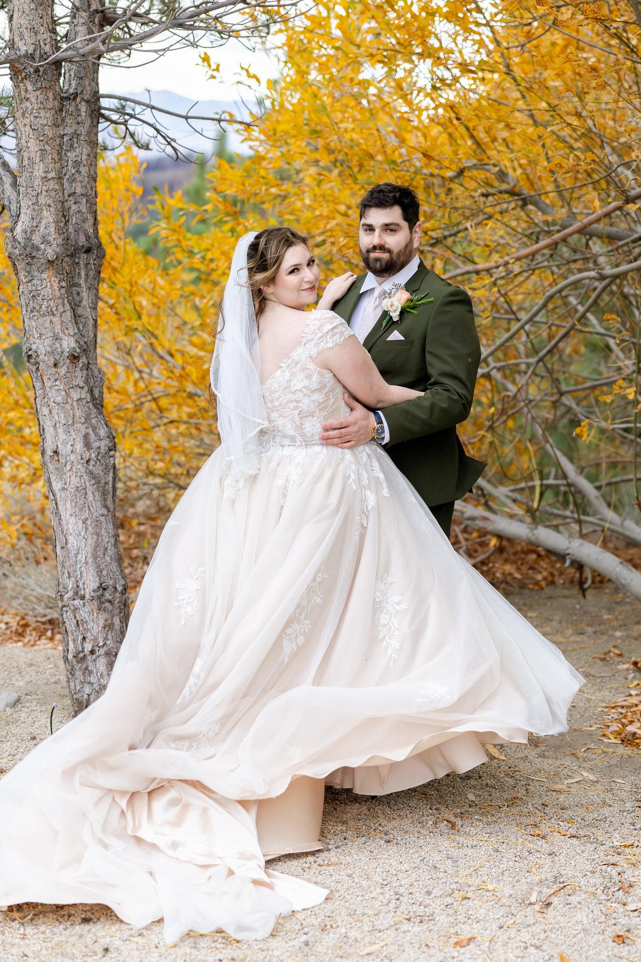 Danielle's skirt swirls as Brandon smiles behind her among the aspens