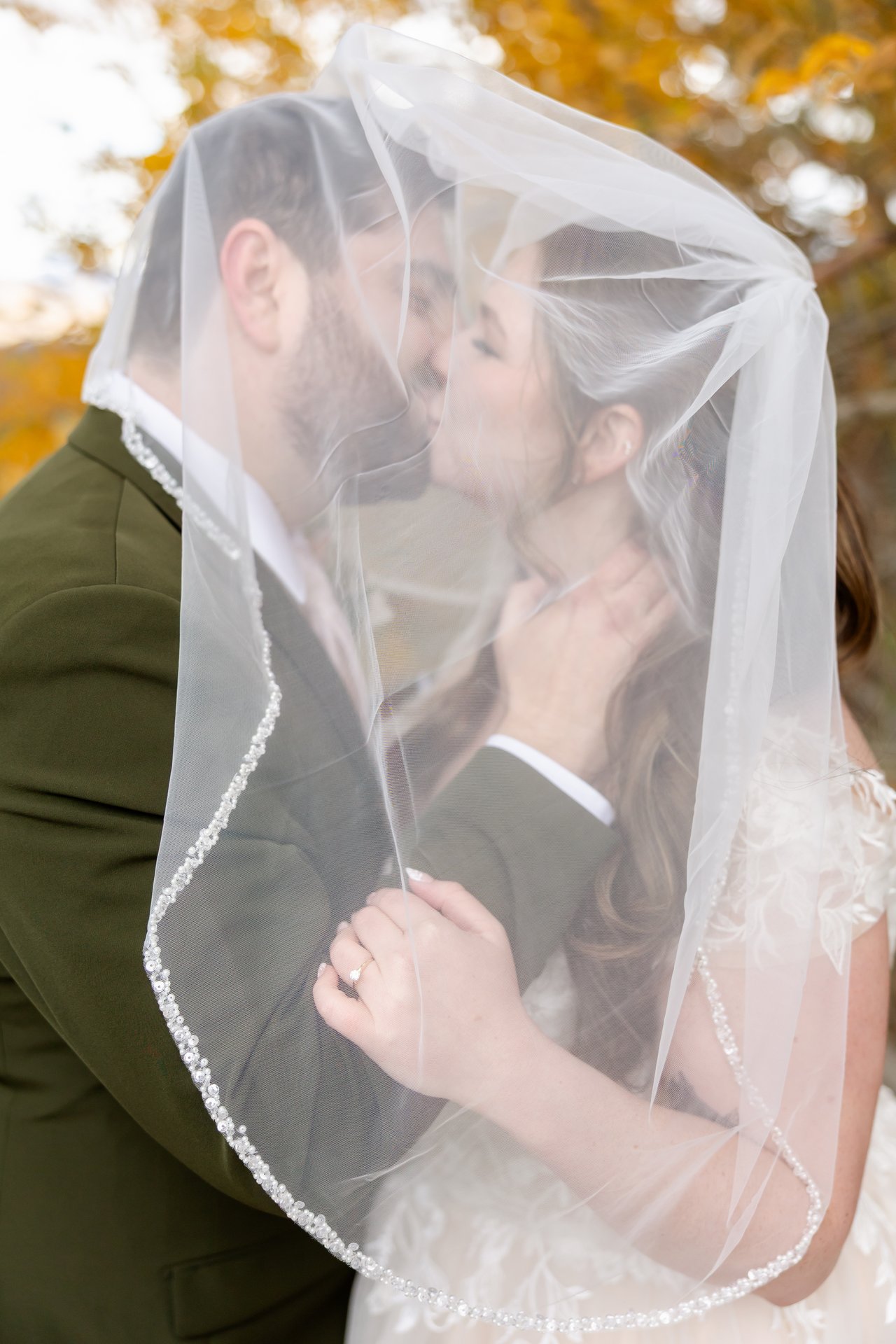 Danielle and Brandon kiss under her veil