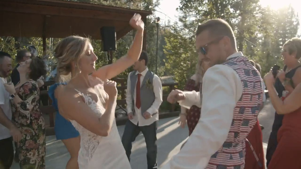 Danielle and Scott dance with guests under the patio cover.