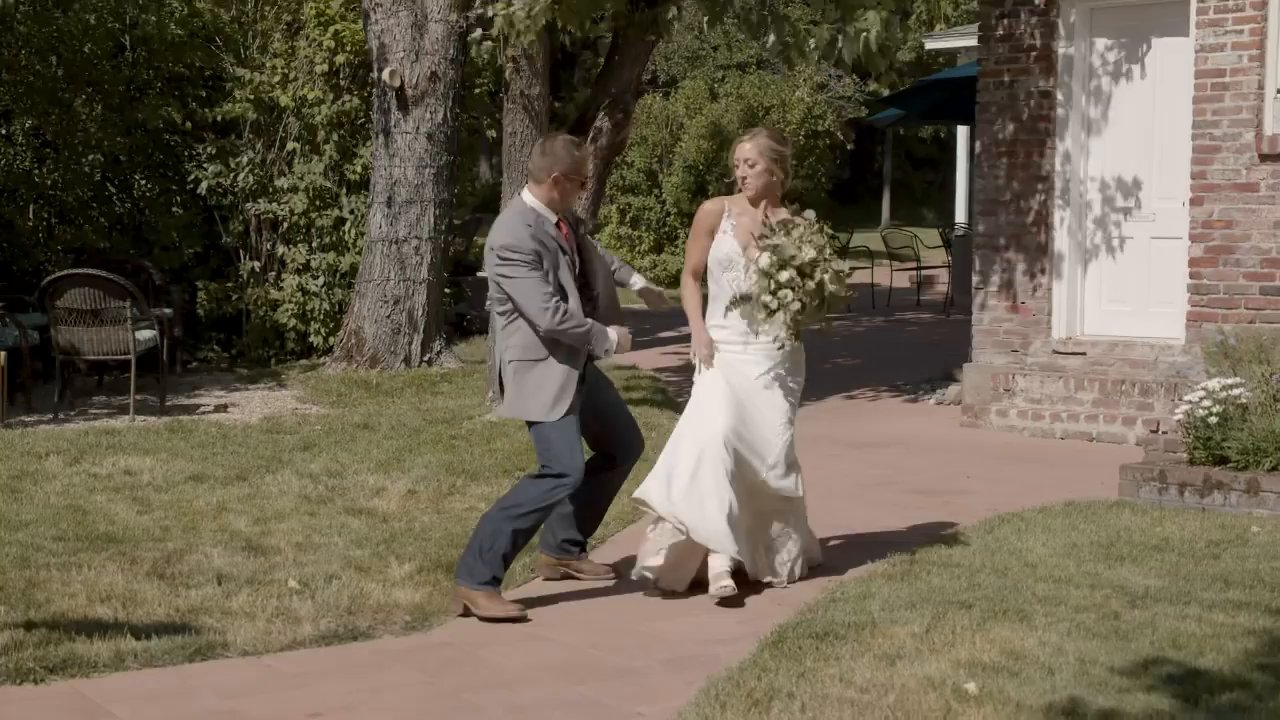 Scott and Danielle dance up the brick path into the reception.