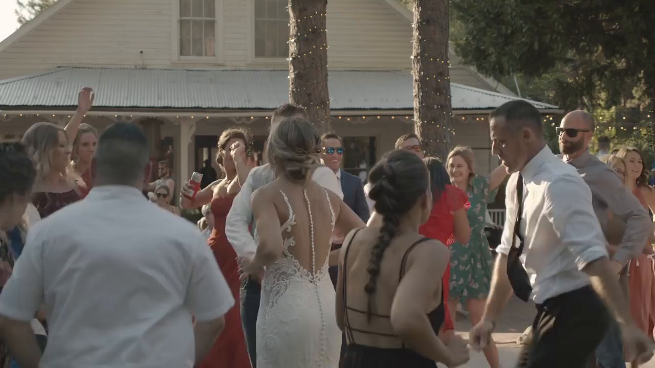 Danielle dances with friends in a circle on the patio.