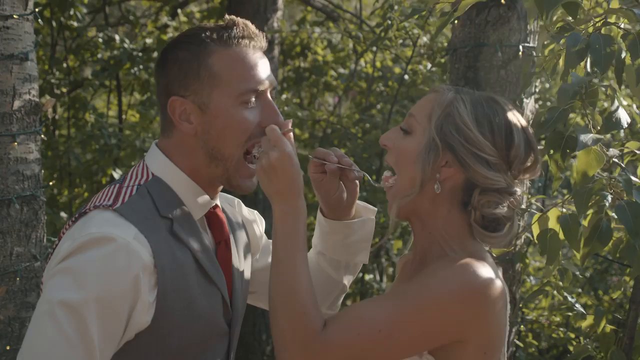 Danielle feeds Scott a bite of cake as they both laugh.